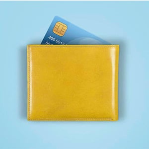 A yellow wallet with a bank card sticking out the top