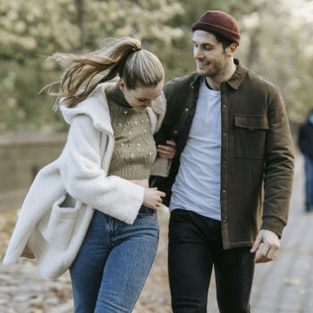 A happy young couple walking down a street