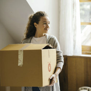 Woman carrying a moving box