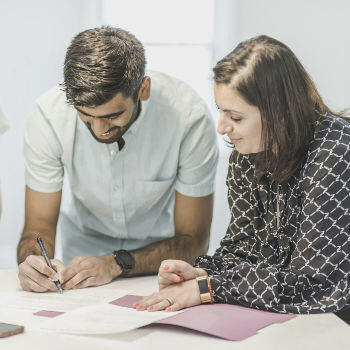 A couple signing some documents